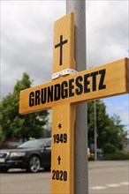 Symbolic grave cross with inscription on the Basic Law at a protest organised by critics of the
