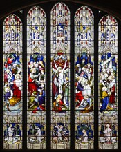 Stained glass window showing biblical scenes including Crucifixion, Norwich Cathedral, Norfolk,