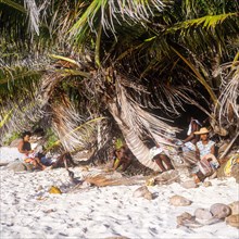 Seychelles, Fregate, locals on the white sandy beach of Anse Victorin, Africa