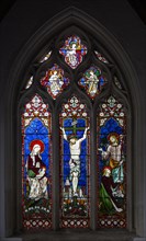Stained glass window of crucifixion Church of Saint John the Baptist, Pewsey, Wiltshire, England,