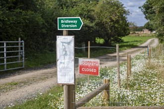 Footpath closed bridleway alternative route diversion signs in countryside at Sutton, Suffolk,