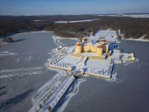 Moritzburg Castle on the castle island surrounded by the frozen castle pond, Moritzburg, Saxony,