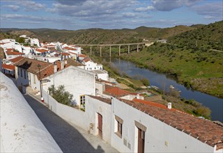 Landscape view of valley of river Rio Guadiana over rooftops in the medieval village of Mertola,
