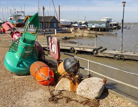 Marine navigation buoys on quayside at Felixstowe Ferry, Suffolk, England, UK