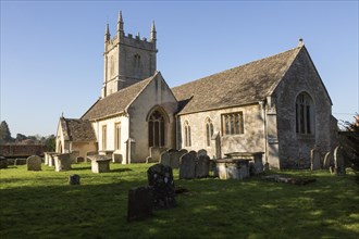 Graves in the graveyard of the village parish church of Saint James the Greater, Dauntsey,