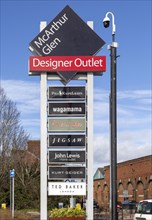 McArthur Glen designer outlet sign listing some of the shops, Swindon, Wiltshire, England, UK