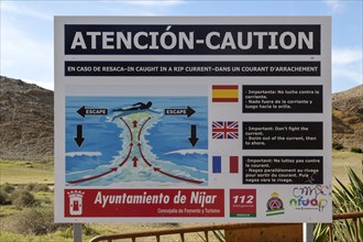 Beach sign caution auto swimmers about danger of rip current, Cabo de Gata natural park, Almeria,