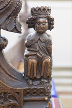 A seated King. Fifteenth century carved wooden pew bench ends of human figures and fantastical