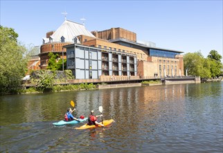 Royal Shakespeare Company theatre and canoeists on the River Avon, Stratford-upon-Avon,