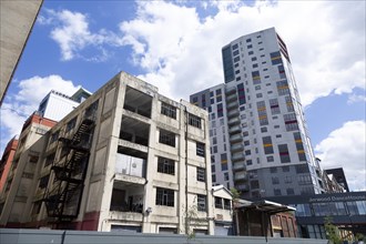 Contrast derelict industrial building modern housing development high rise flats, Wet Dock