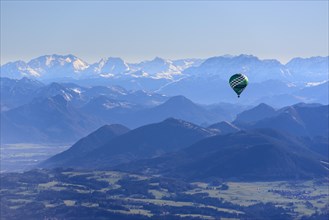 Hot air balloon flying in front of a mountain landscape, Montgolfiade Tegernsee Valley, Balloon