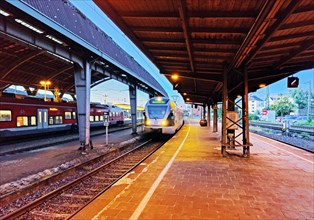 Deserted platform with arriving train in the evening, main station, Hagen, North Rhine-Westphalia,