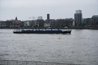 Cargo ship on the Rhine, historic city centre behind, Cologne, Germany, Europe