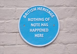 Humorous fake blue plaque sign on wall of house 'British Heritage Nothing of Note Has Happened
