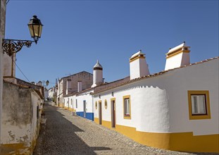 Traditional architecture with large chimneys in whitewashed houses and street in the small rural