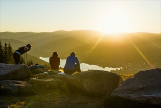 Hiking group, view from Hochfirst to Titisee and Feldberg, sunset, near Neustadt, Black Forest,