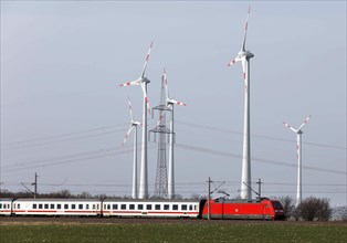 A Deutsche Bahn train passes a wind farm, Nauen, 03/03/2021