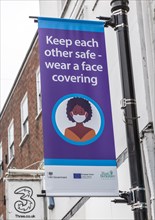 Keep each other safe wear a face covering Covid 19 information poster, Newbury, Berkshire, England,