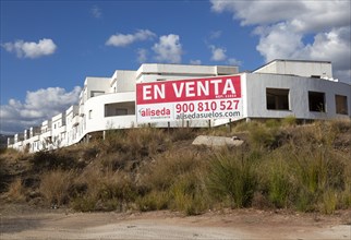 Unfinished housing project property for sale sign, near Alcaucin, La Axarquia, Andalusia, Spain,