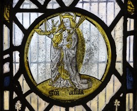 Saint Ursula medieval stained glass window roundel inside the church at South Elmham All Saints,