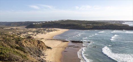 Panorama view of river mouth of Ribeira de Aljezur reaching the Atlantic Ocean and whitewashed