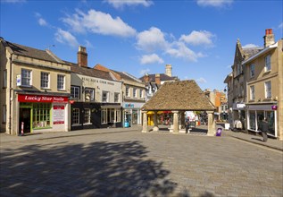 Historic buildings around the 16th century Buttercross, in Market Place, Chippenham, Wiltshire,