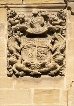 Family coat of arms carved in stone on corner of historic building, crest of Don Pedro Mendoza