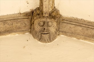 Carved wooden figure of a face in Metfield church porch, Suffolk, England, UK