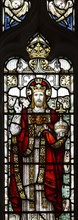 Stained glass window of Jesus Christ in his majesty wearing a crown, church of Saint Mary, Friston,
