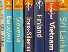 Close up of various travel guide books published by Lonely Planet and Rough Guides
