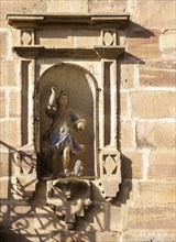 Historic buildings in town of Ezcaray, La Rioja Alta, Spain statue in niche of building
