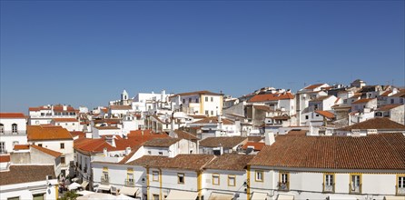Panoramic style cityscape views over pan tile rooftops and whitewashed buildings in the city centre