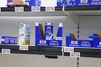 Empty milk shelf in a supermarket in Germany