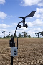Sencrop Windcrop V7 weather vane anemometer weather station equipment in farm field, Sutton,