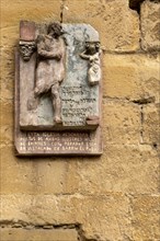 Roman style memorial plaque on church wall, Santa Maria de la Asuncion, Briones, La Rioja Alta,
