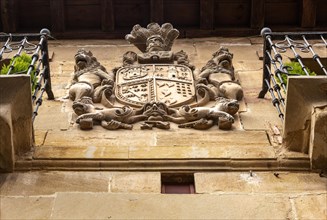 Family coat of arms carved in stone on corner of historic building, San Asensio, La Rioja Alta,