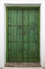Faded green paint traditional wooden house door, Frigiliana, Axarquia, Andalusia, Spain, Europe