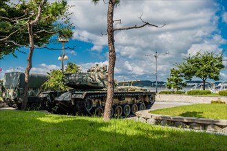 Rear side view of M48 tank on display at seaside park under blue cloudy sky in Seosan, South Korea,