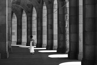 Lady in a white dress in the arcade of the Congress Hall, unfinished National Socialist monumental