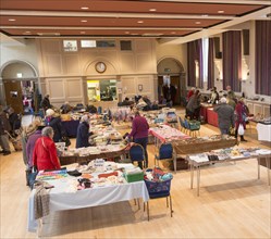 Shoppers browsing stalls at a Flea market inside the Corn Exchange building, Devizes, Wiltshire,