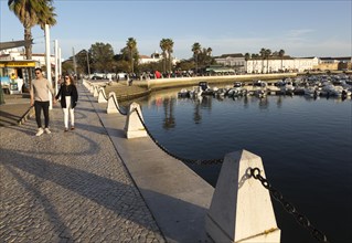 Activity around the marina area with people walking along the waterfront, Faro, Algarve, Portugal,