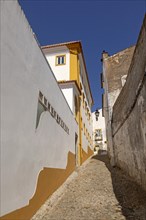 Residential buildings in cobbled alley with historic whitewashed houses. An image of life one of