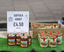 Display of jars of Suffolk honey on sale at street market, England, UK