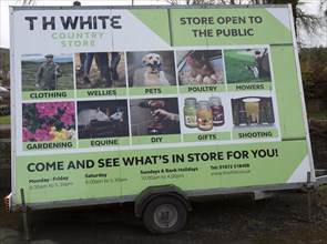 Mobile wheeled advertising hoarding for TH White country store shop, Marlborough, Wiltshire,