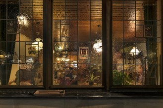Evening view through the window into an illuminated restaurant, Lauf an der Pegnitz, Middle