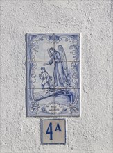 Azulejo tile ceramic image of guardian angel above house door, village of Alvito, Baixo Alentejo,