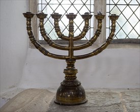 Brass candlestick holder six arms inside Holy Trinity church, Blythburgh, Suffolk, England, UK