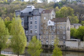Former industrial buildings converted to housing, River Avon, Bath, Somerset, England, UK