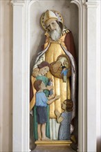 Sculpture statue of Saint Nicholas with children inside village parish church of Saint Nicholas,