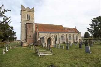 Graves in the churchyard of the village parish church of Saint Mary, Ellingham, Norfolk, England,